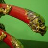 The flying dragon motif is repeated in the pommel and guards of both swords.