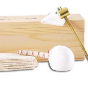 Aka 1003-GT, the kit contains blade oil (traditional choji oil), rice papers, an oiling cloth, a powder ball for blade polishing, a brass awl and hammer, and saya shimming veneer. The kit is contained in a fitted wooden box.